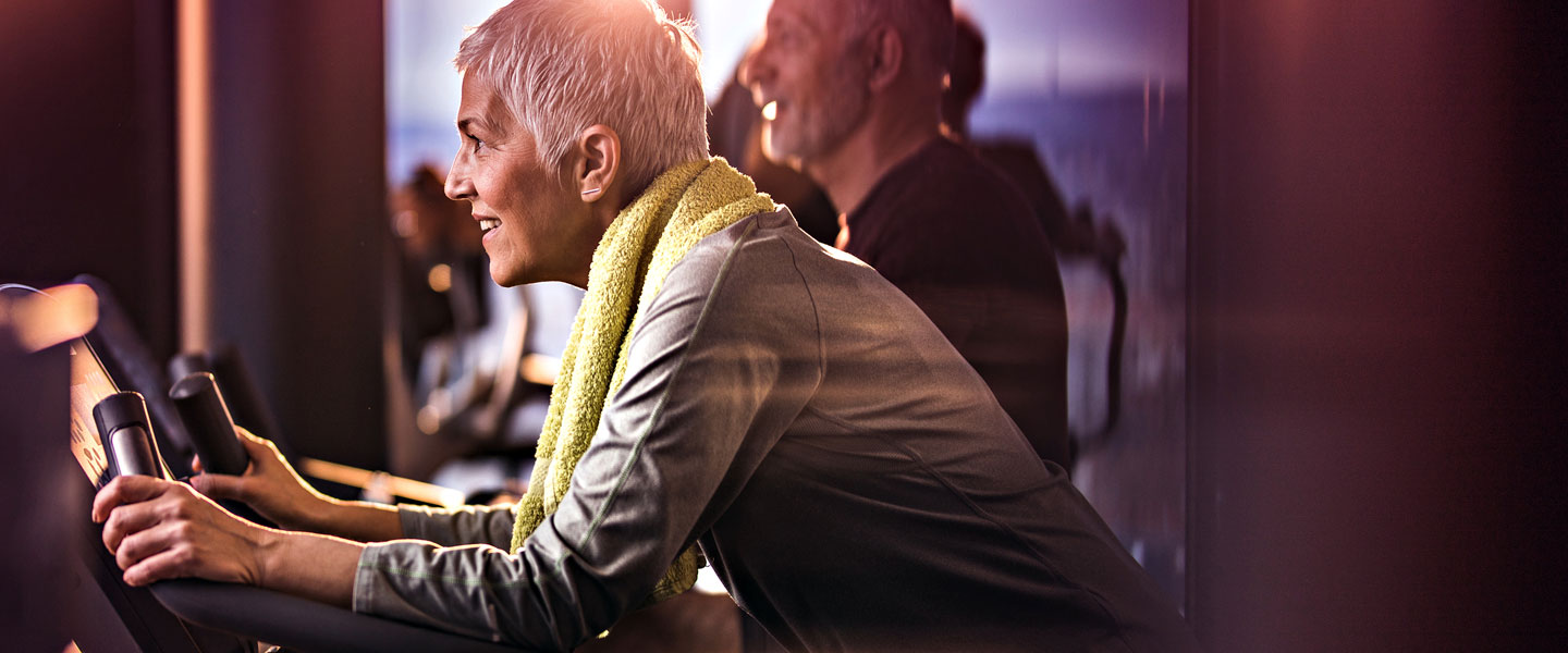 Hero image of a woman on an exercise bike