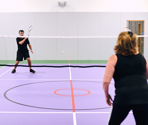 Image of man and woman playing badminton at David Lloyd Clubs