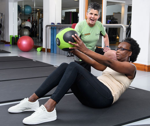 Image of lady with medicine ball during PT session