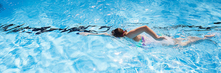 Image of a lady swimming in outdoor pool