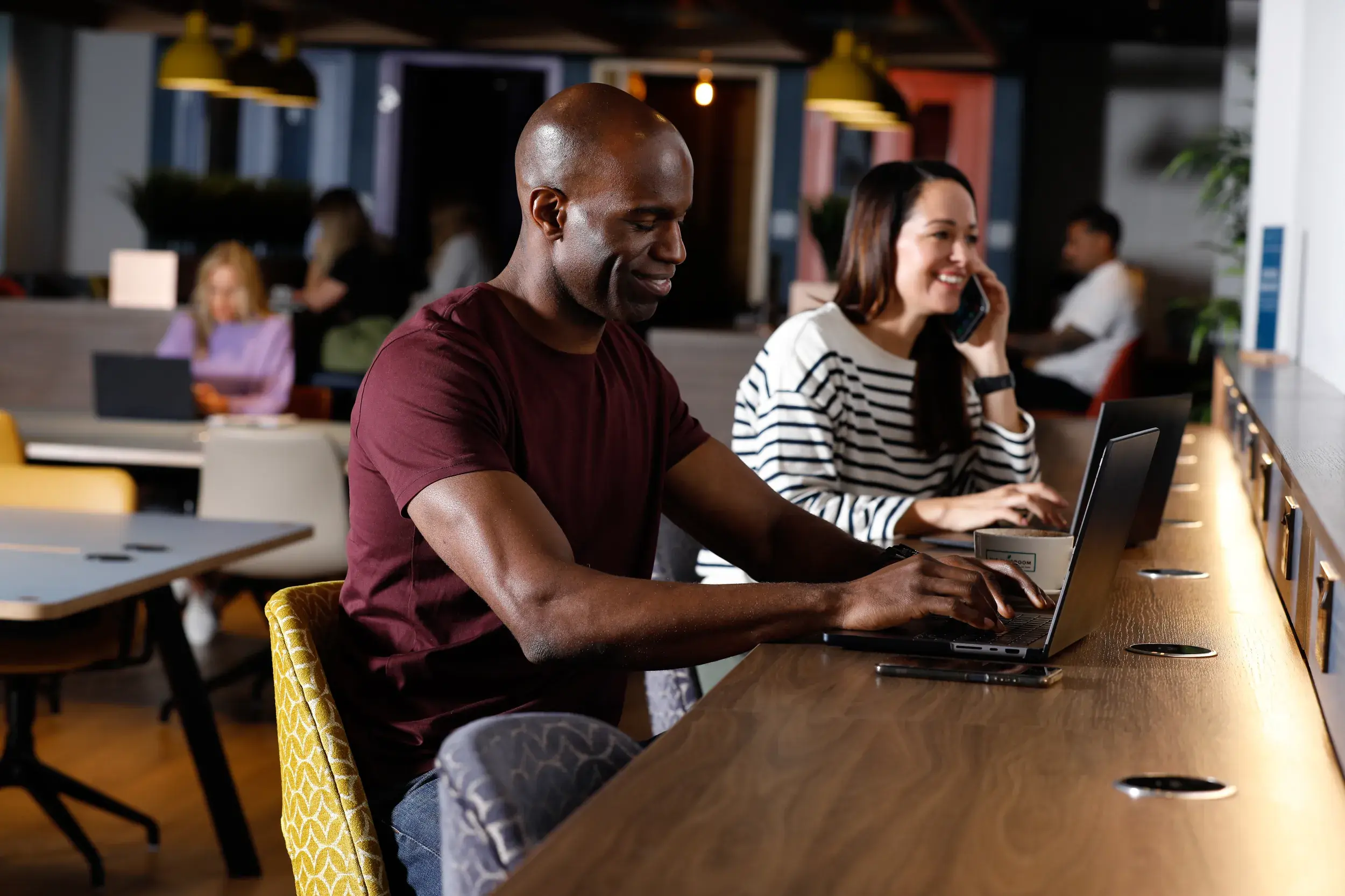 A man and a woman working at a desk