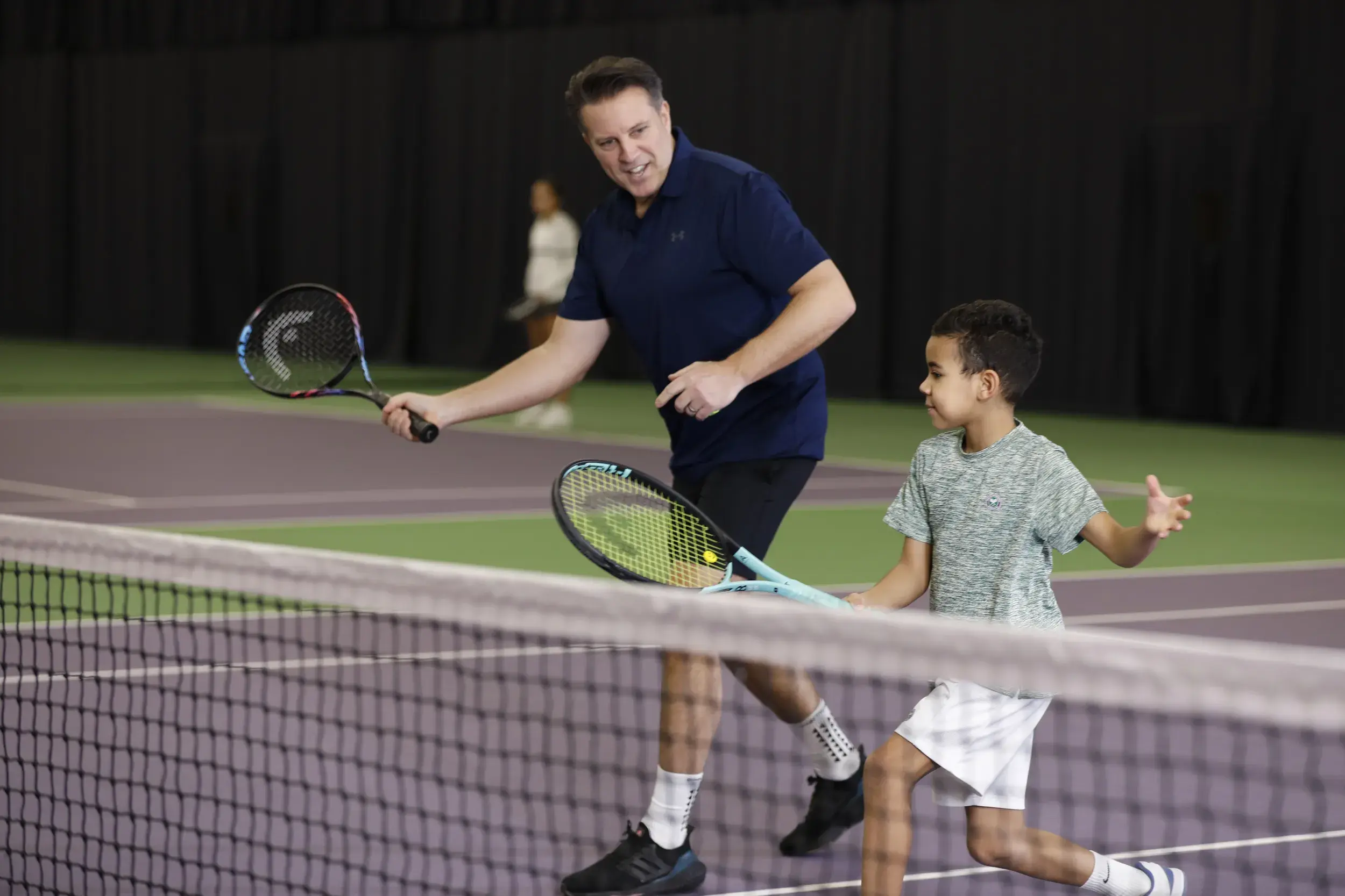 A father and son playing tennis