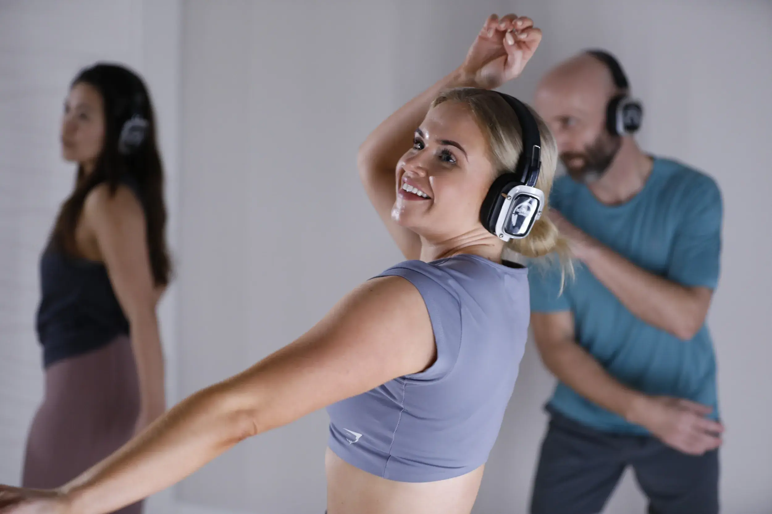 A woman dancing in a spirit sound meditation class