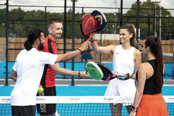 4 people holding Padel racquets