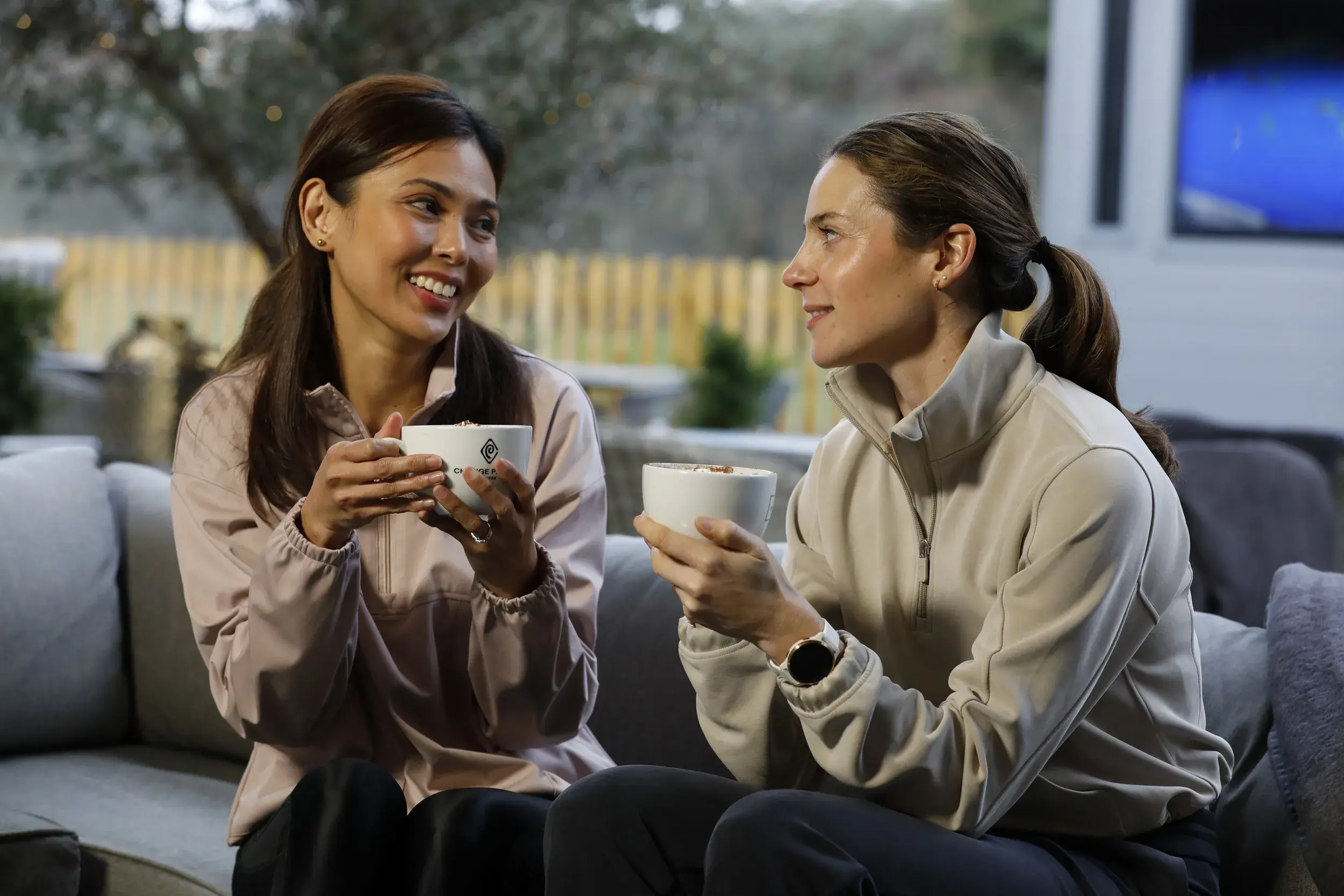 Two women on the terrace enjoying a Change Please coffee