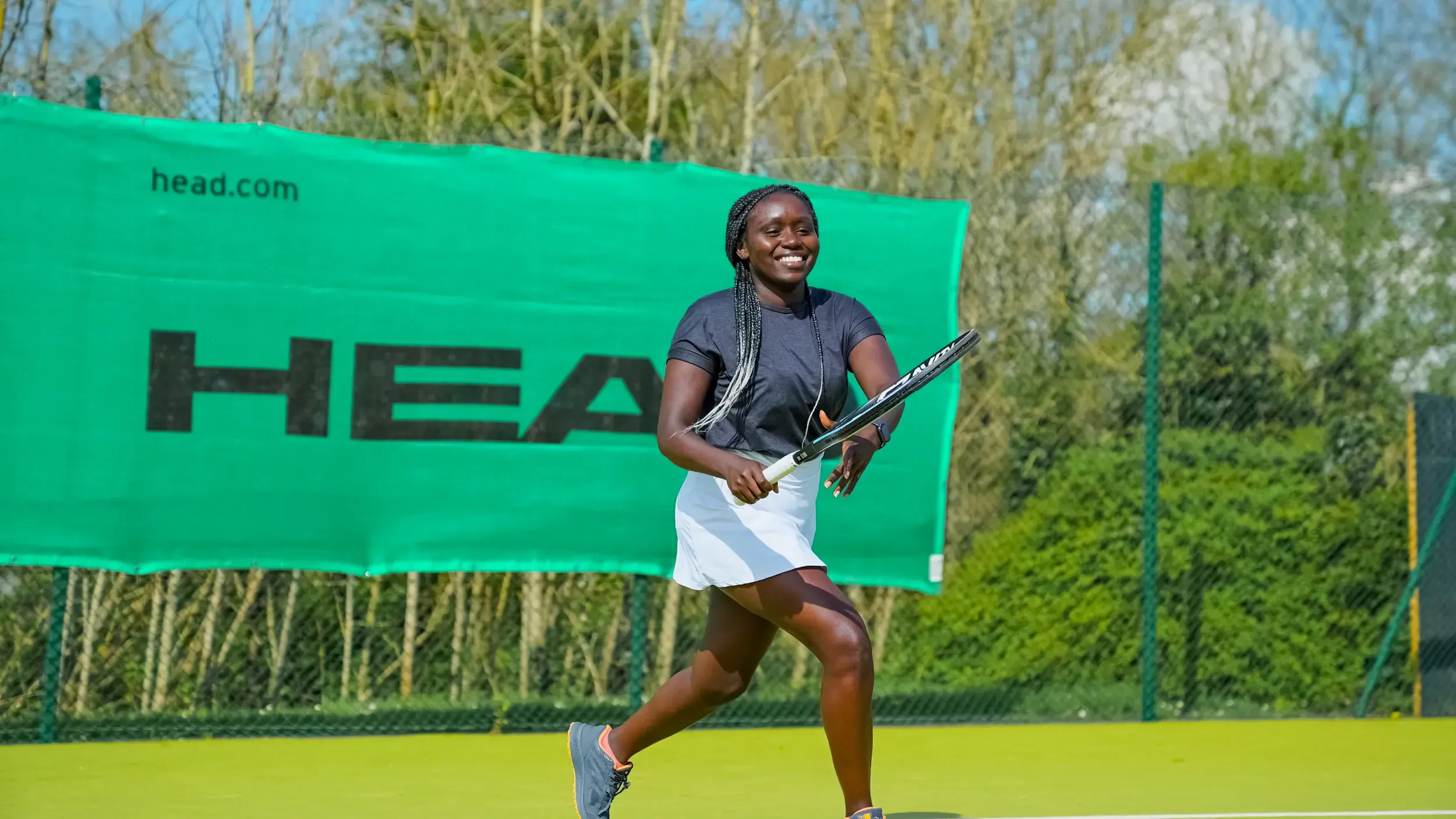 A woman playing tennis on an outdoor court