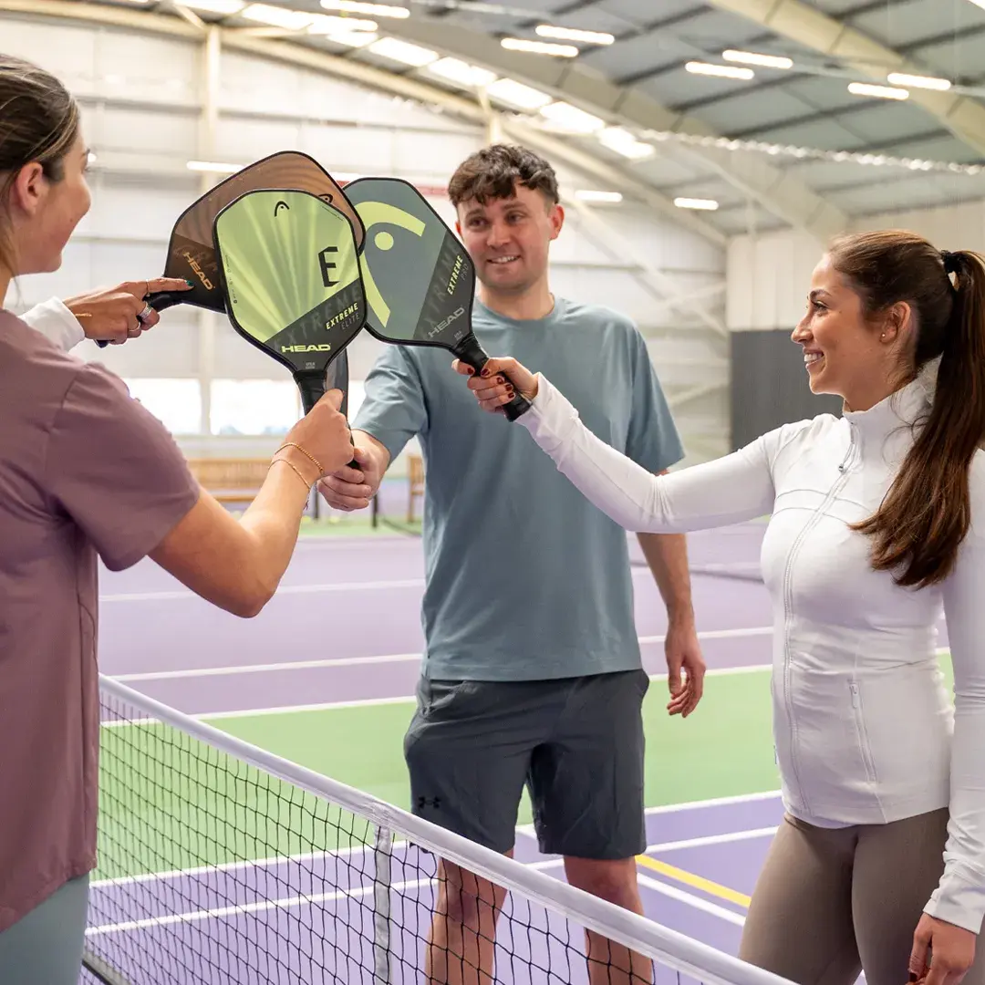 4 players with pickleball racquets