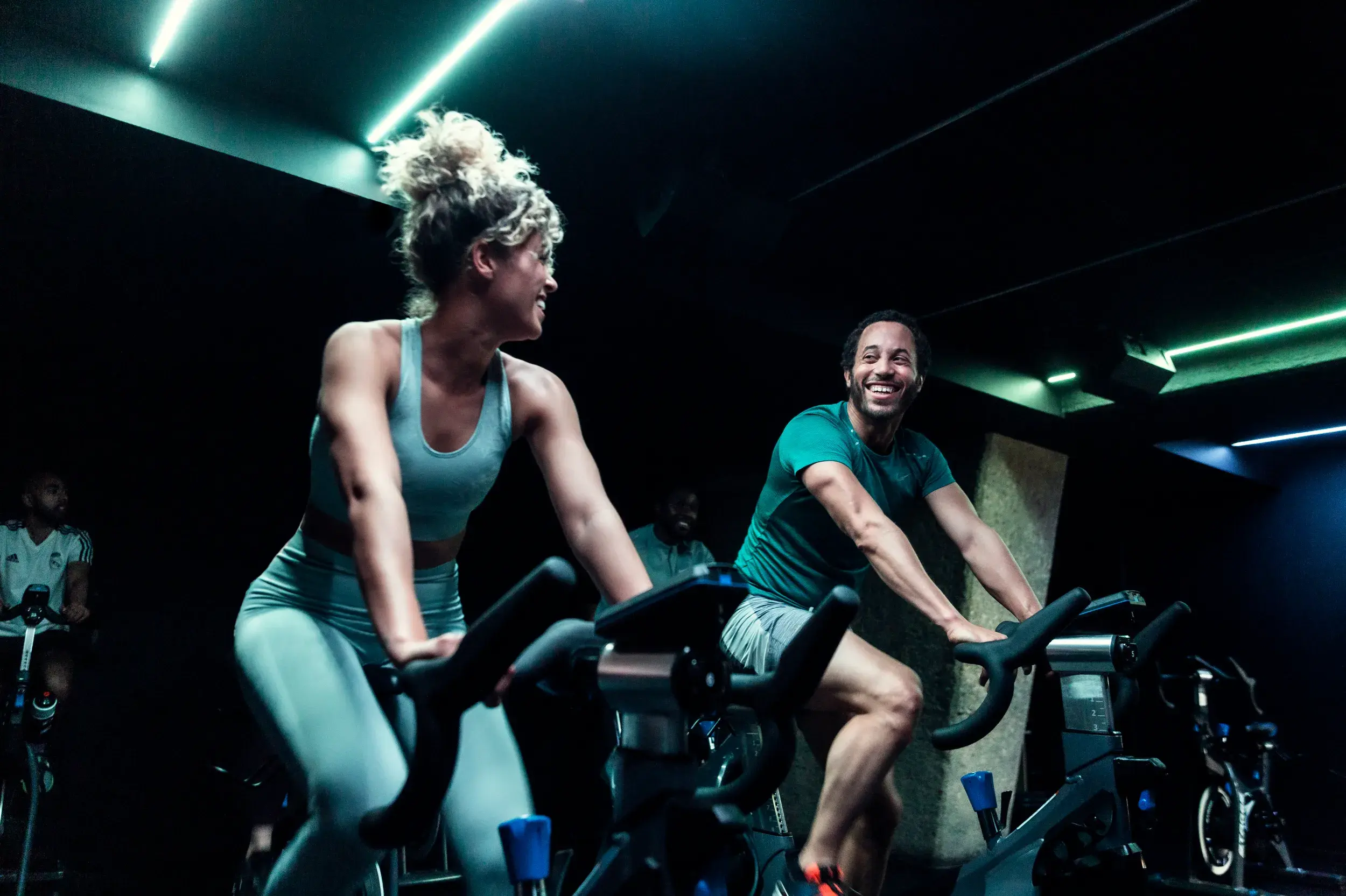 Two people in a group cycling class