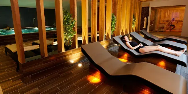 A woman relaxing on a heated bed
