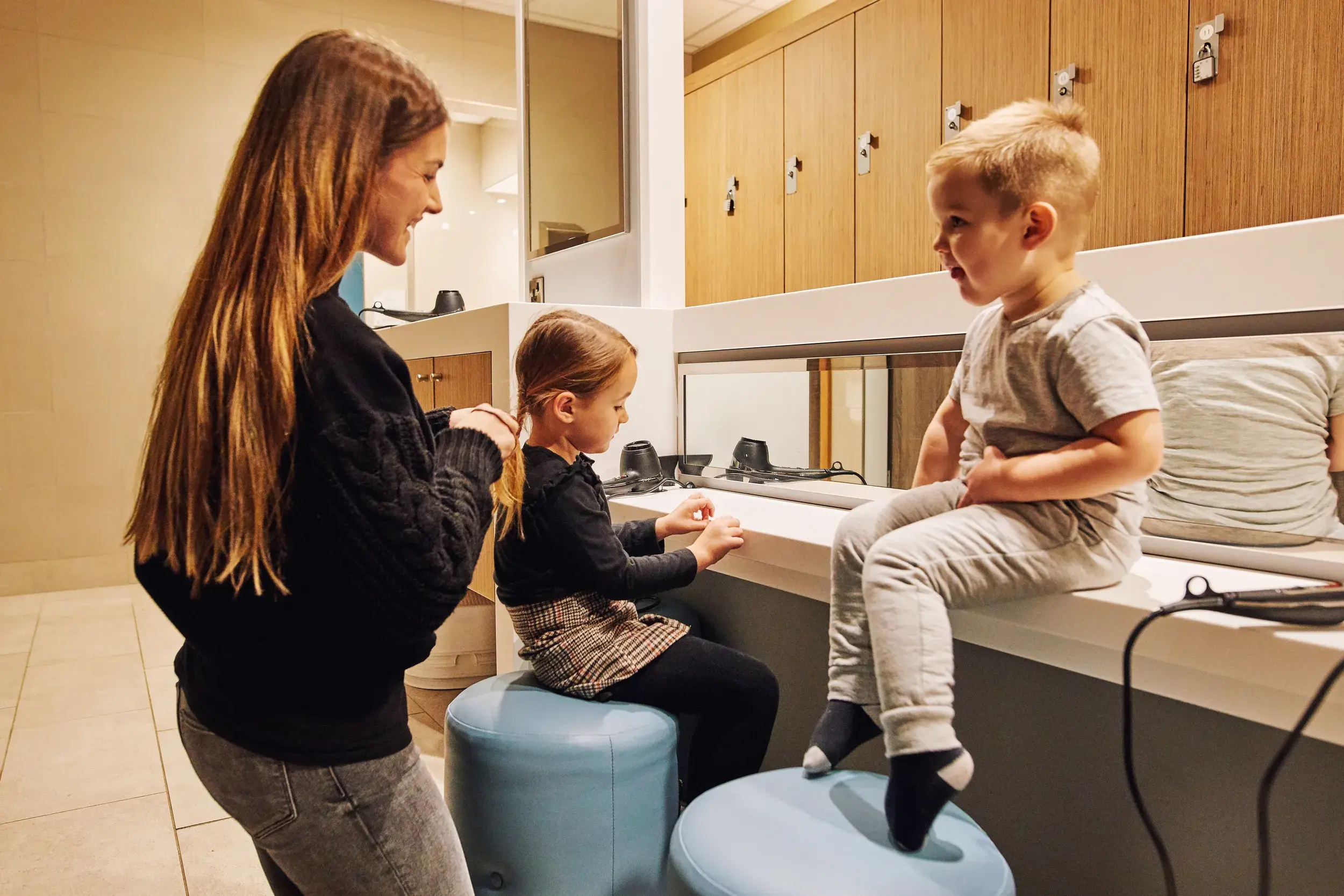 A mum and two children in the changing room
