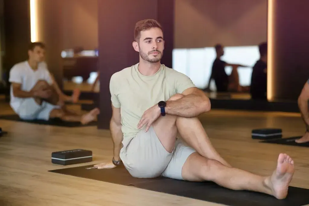 A man doing a seated yoga pose
