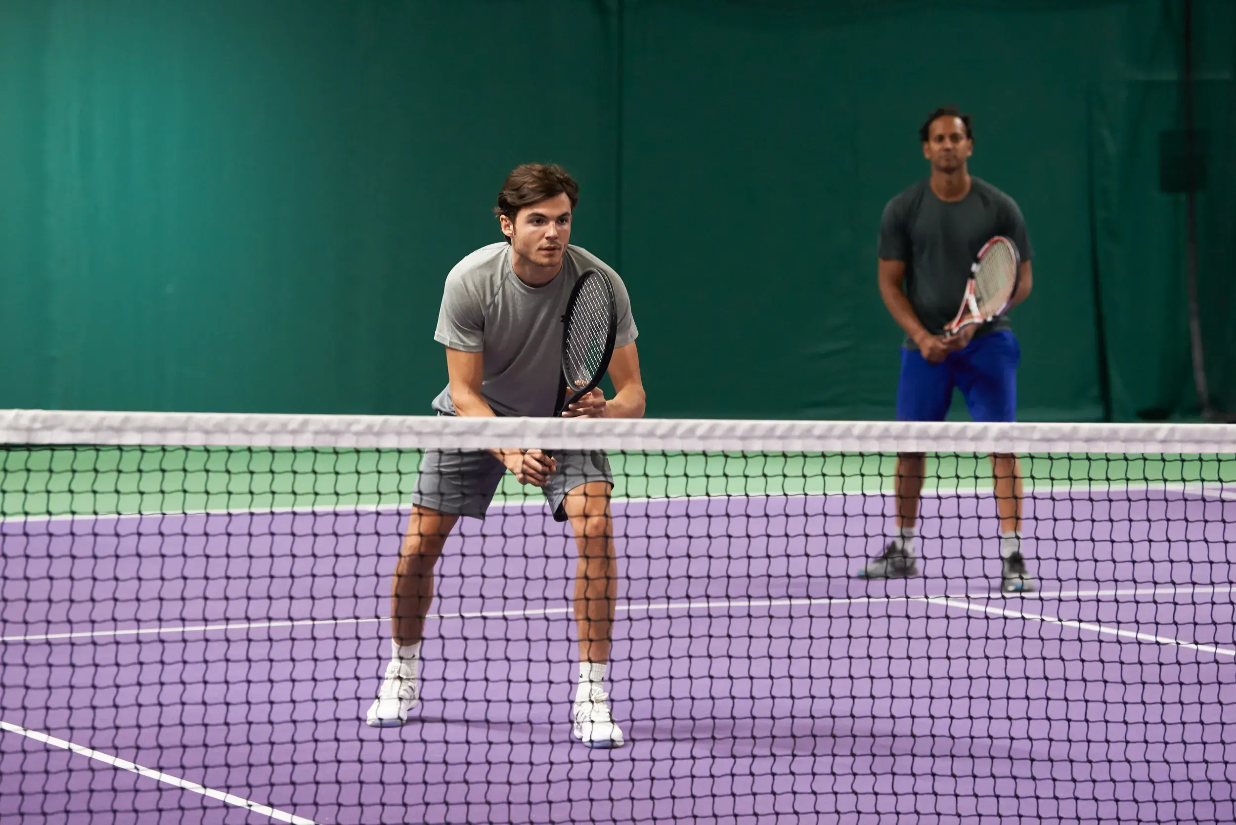 A man at the net during a game of tennis