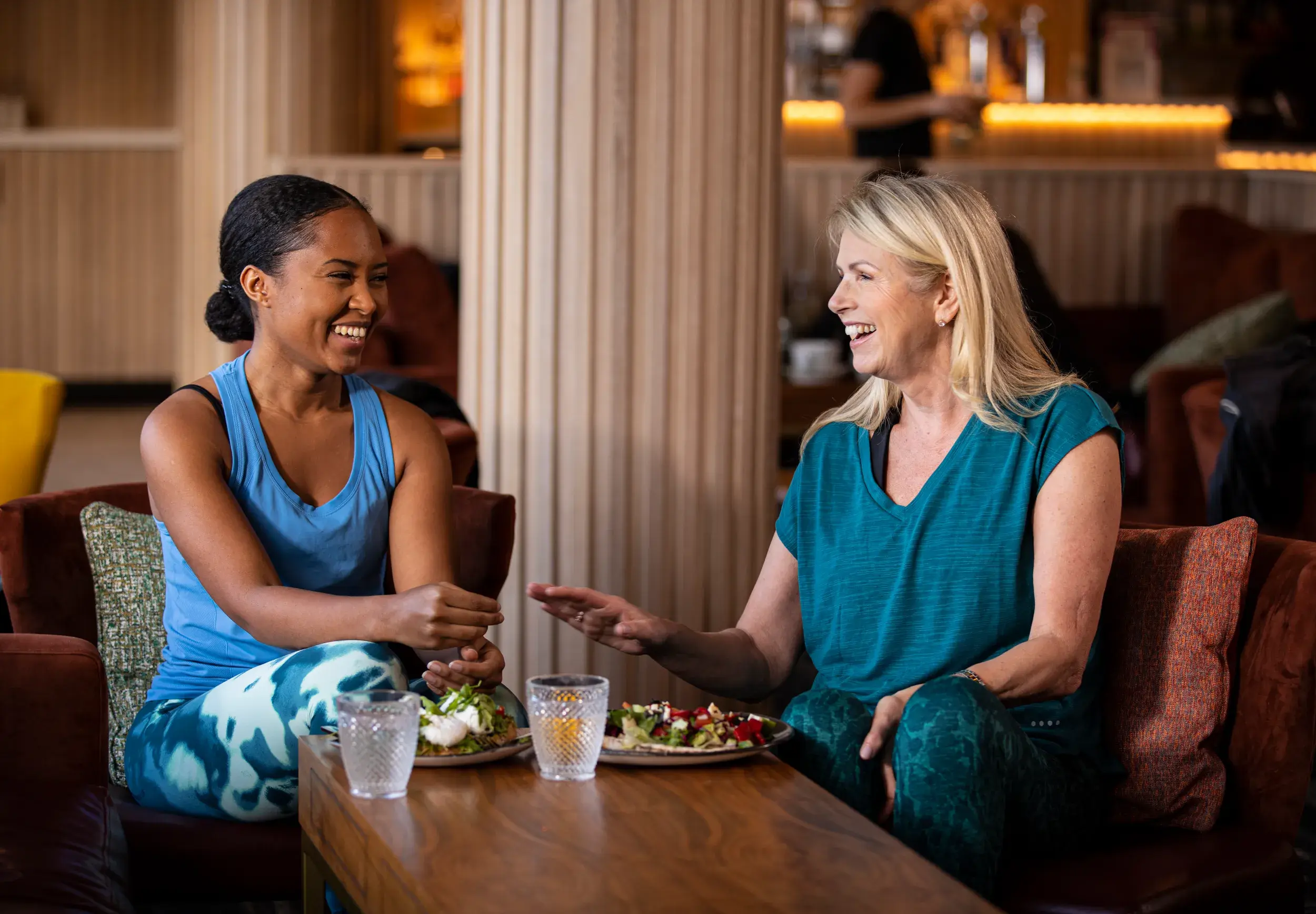 Two women enjoying a drink and a chat in the Clubroom