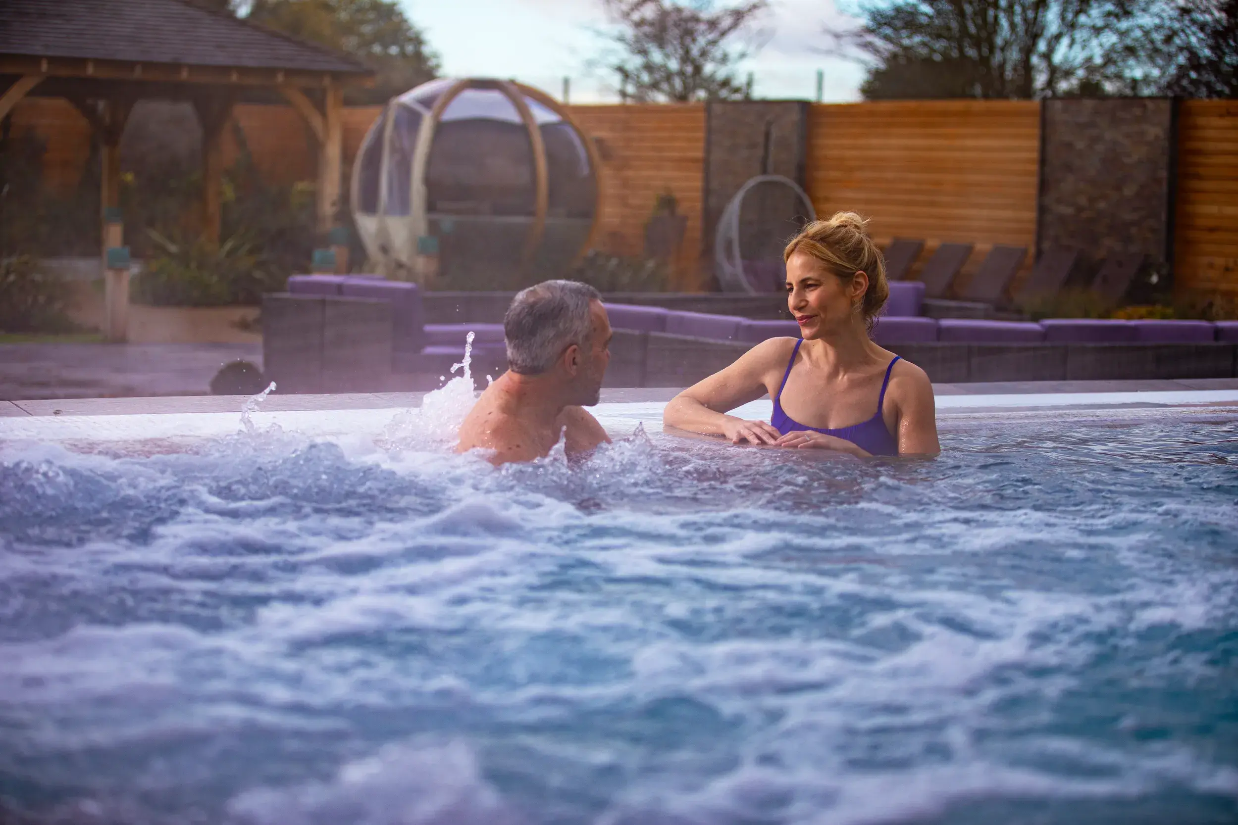 A man and a woman in the outdoor hydro pool