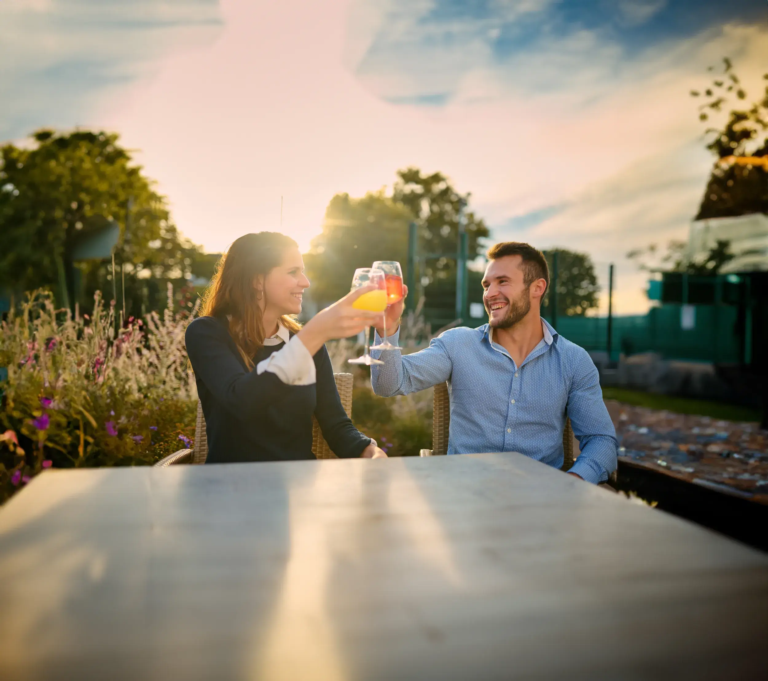 Two women enjoying a drink on the outside terrace