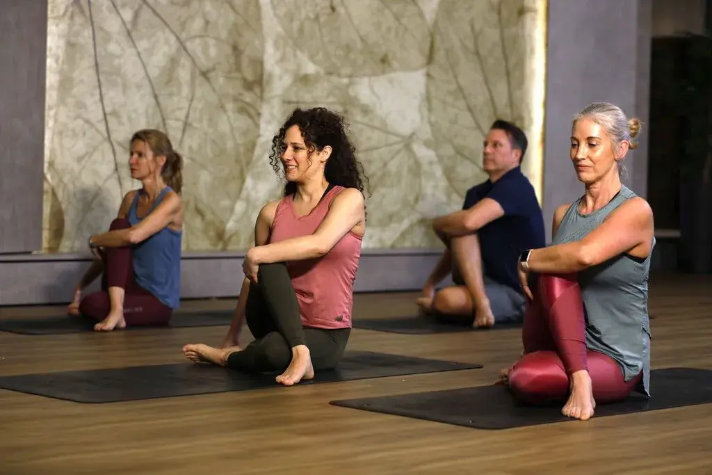 Members stretching in a yoga class
