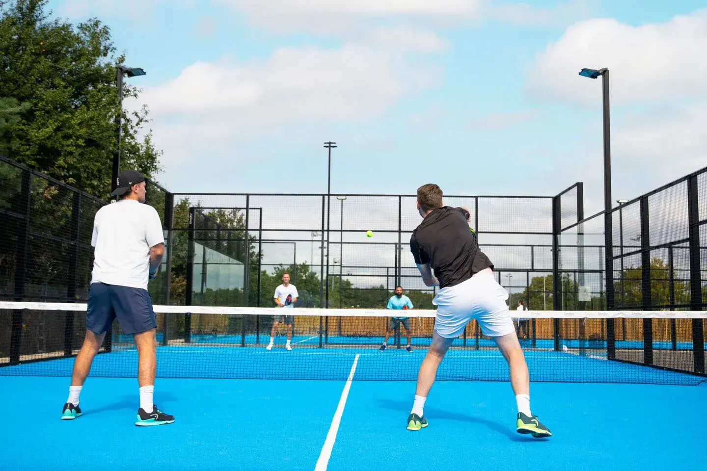4 people playing a game of Padel
