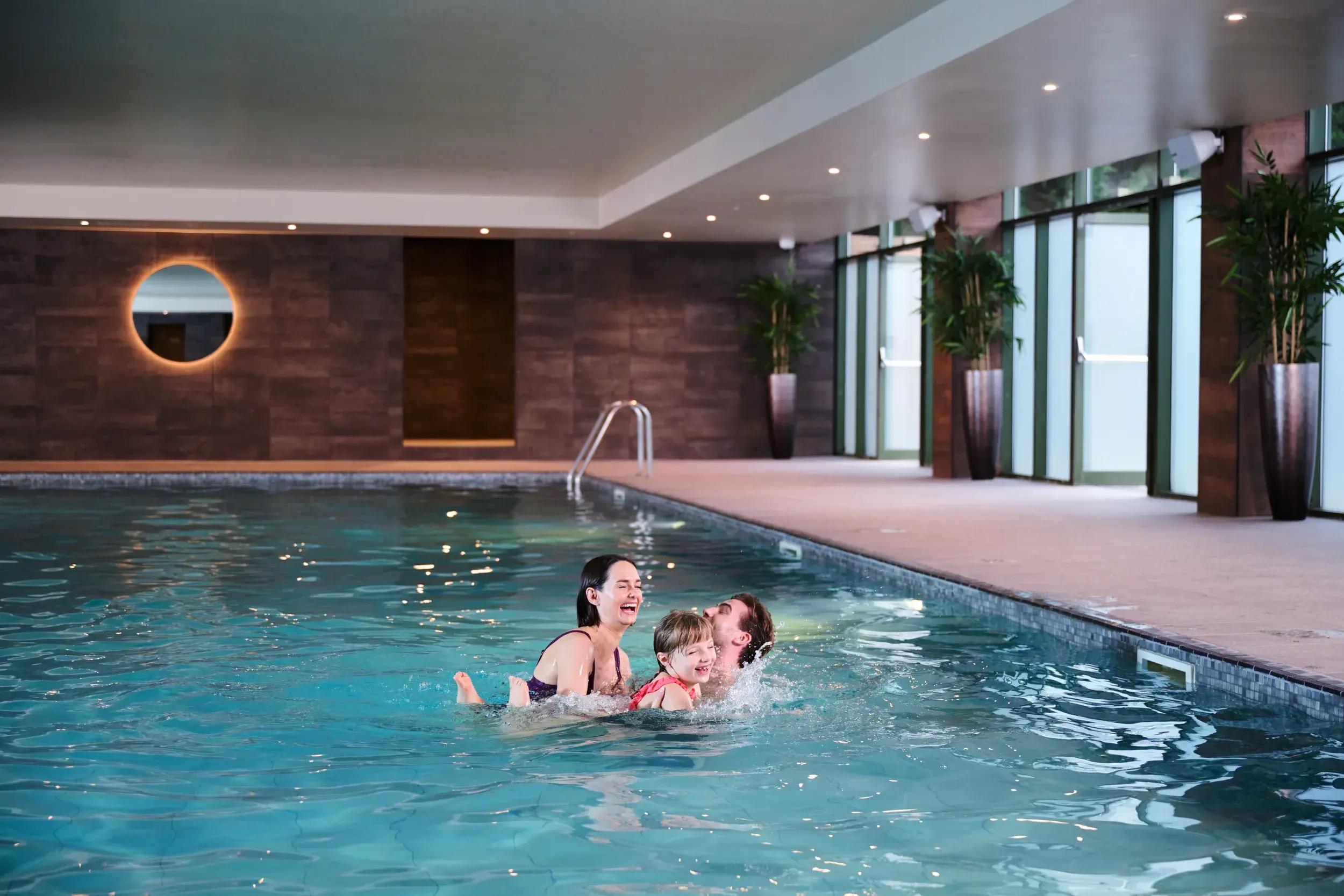 A family swimming indoors