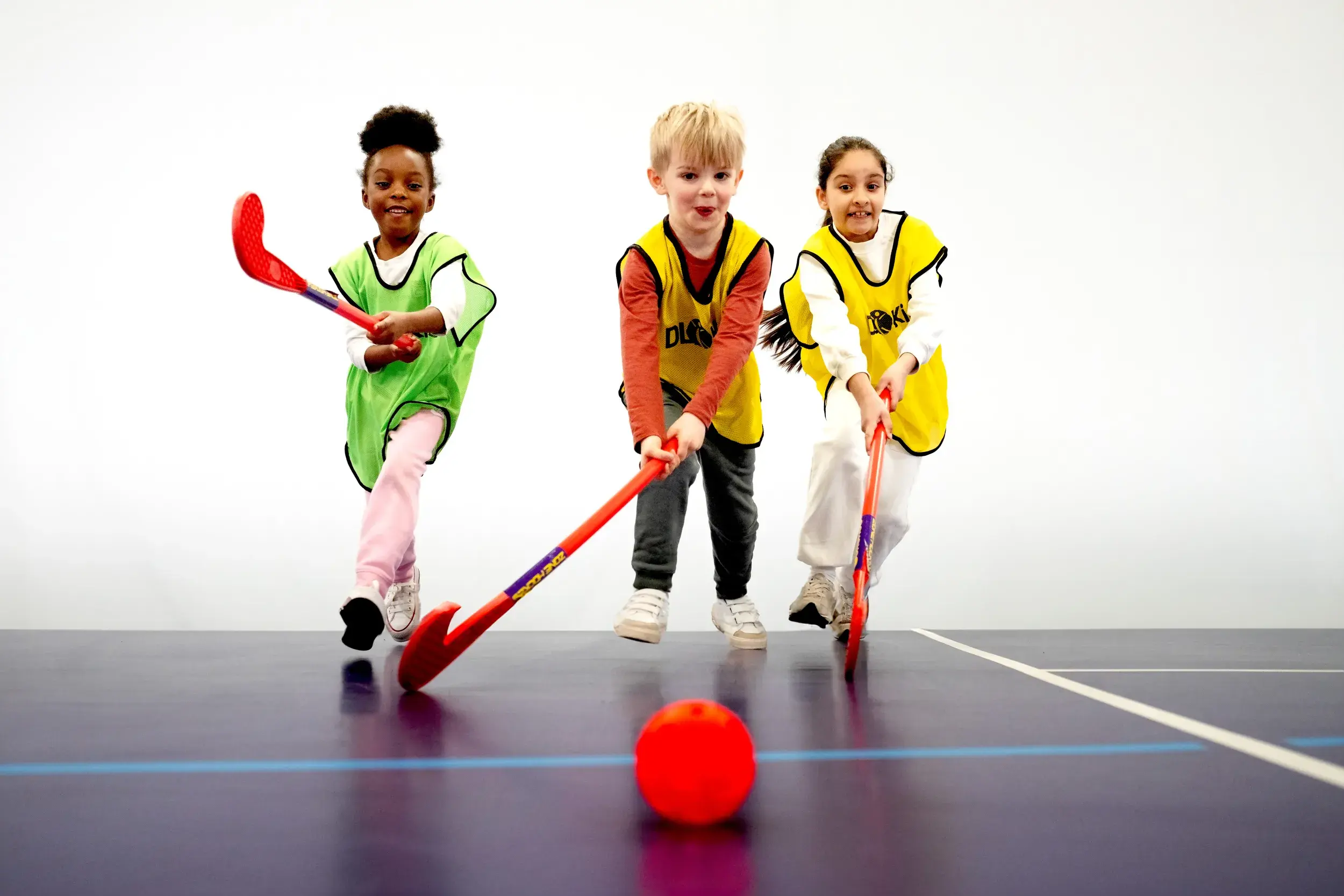 Three children playing hockey