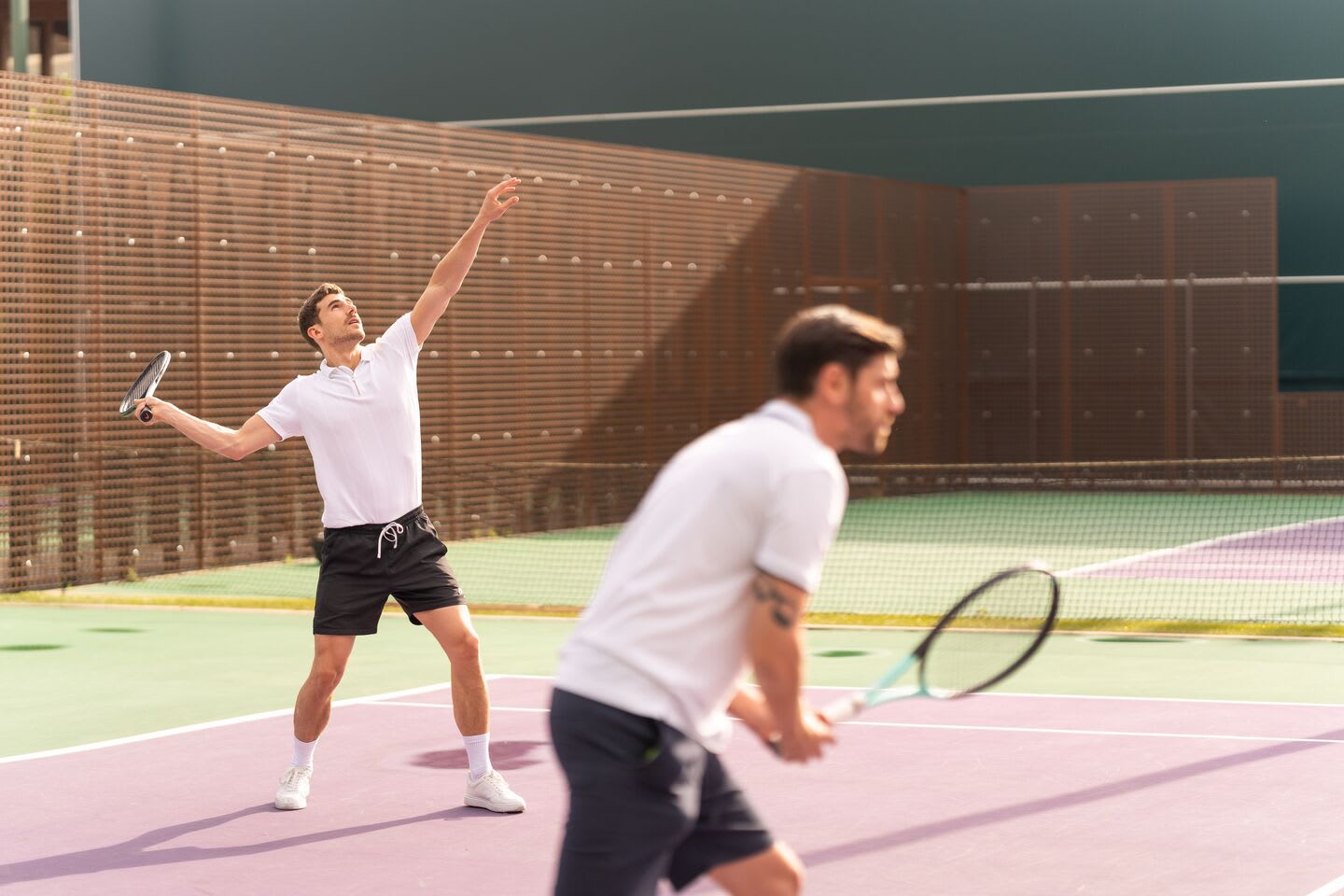 A men on the indoor tennis courts